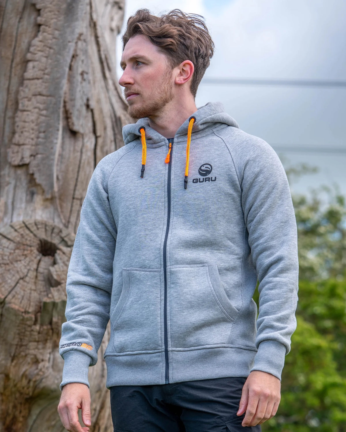 Guru Aventus Hoodie Grey, gedragen vooraanzicht met rits, borstlogo en oranje koorden