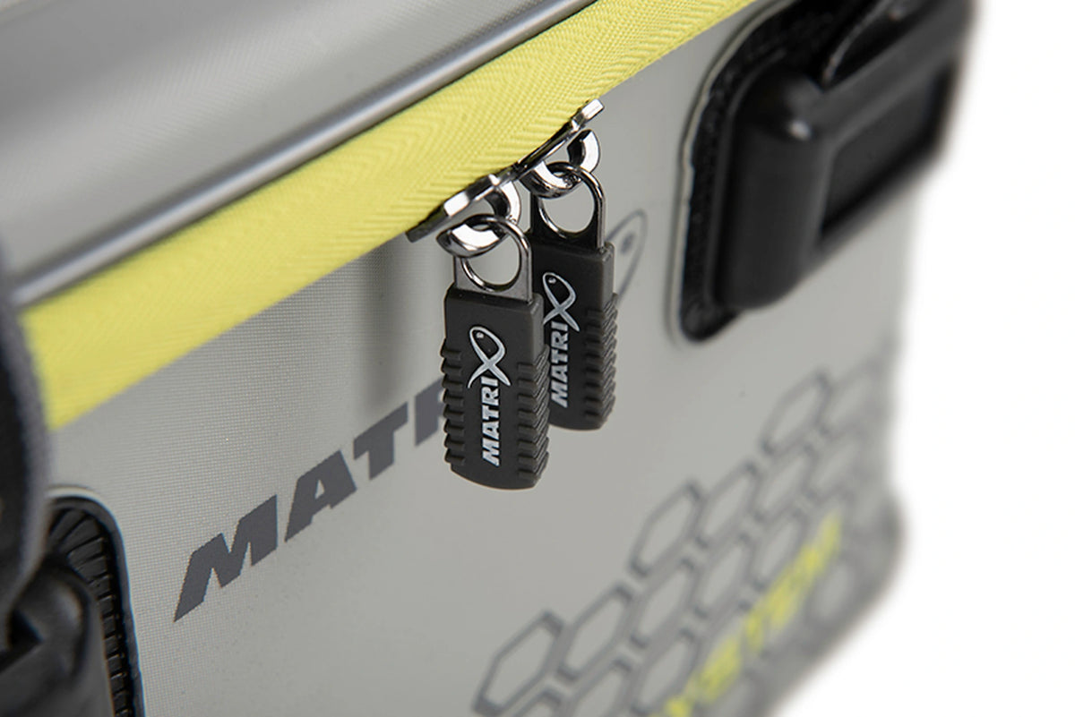Matrix EVA Bait Storage System – close-up van de twee zwarte Matrix-ritstrekkers en de gele rits