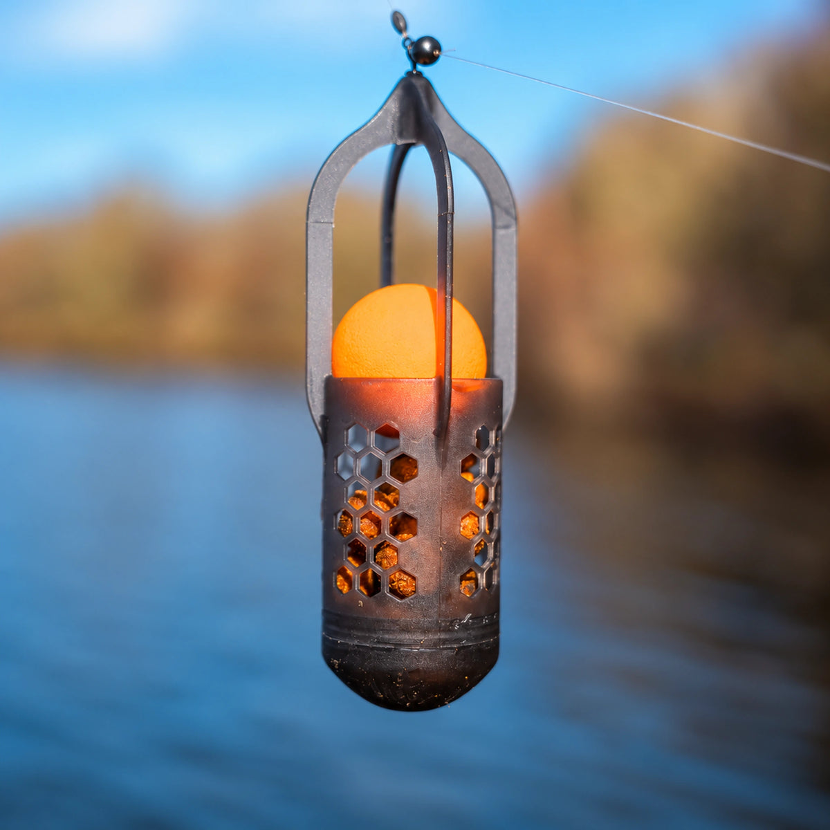Korum Surface Feeder Float K0320112 – hangende voerkorf gevuld met pellets en oranje EVA-bal