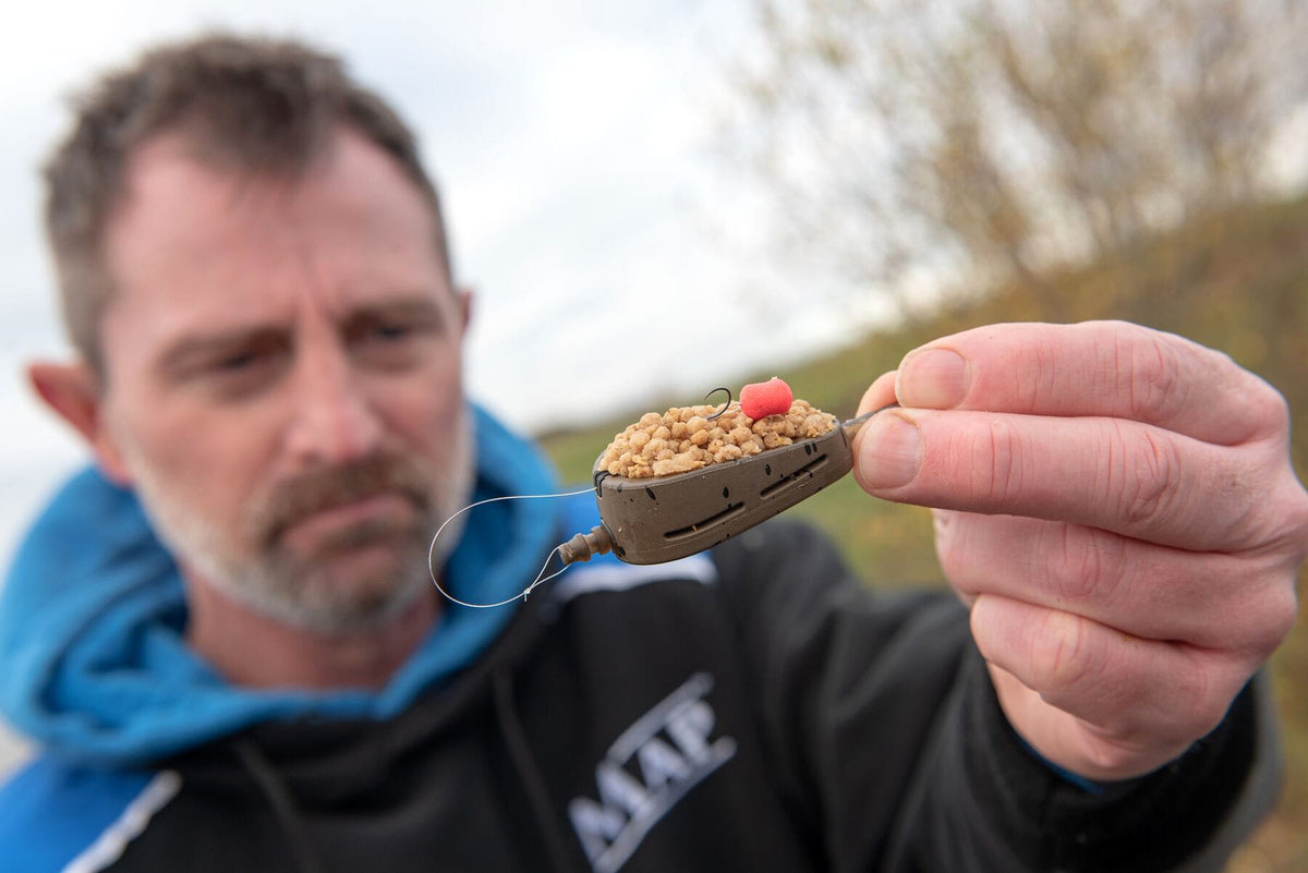 MAP Embed Feeders Inline – visser toont een gevulde methodfeeder met roze haakaas en complete onderlijnmontage