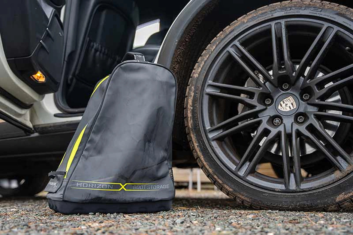 Matrix Horizon X Boot Storage Bag – gesloten laarzentas op grind naast een autowiel en open portier